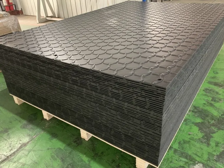 Stacked HDPE ground protection mats ready for export
